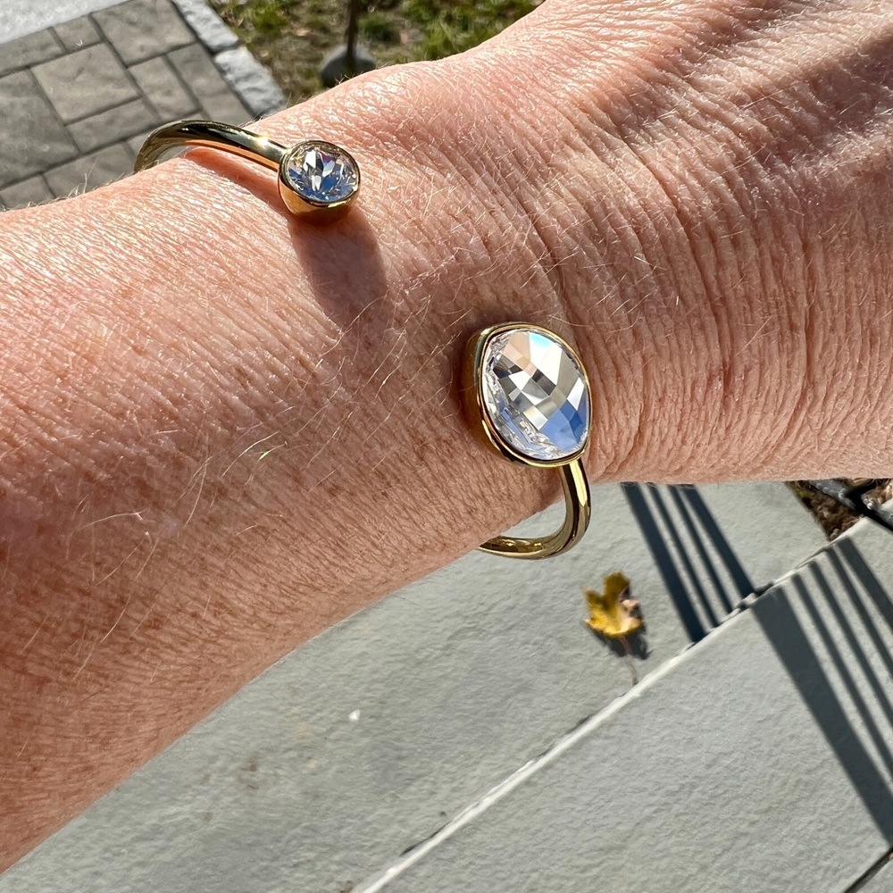 Swarovski touchstone gold tone bangle with clear crystal